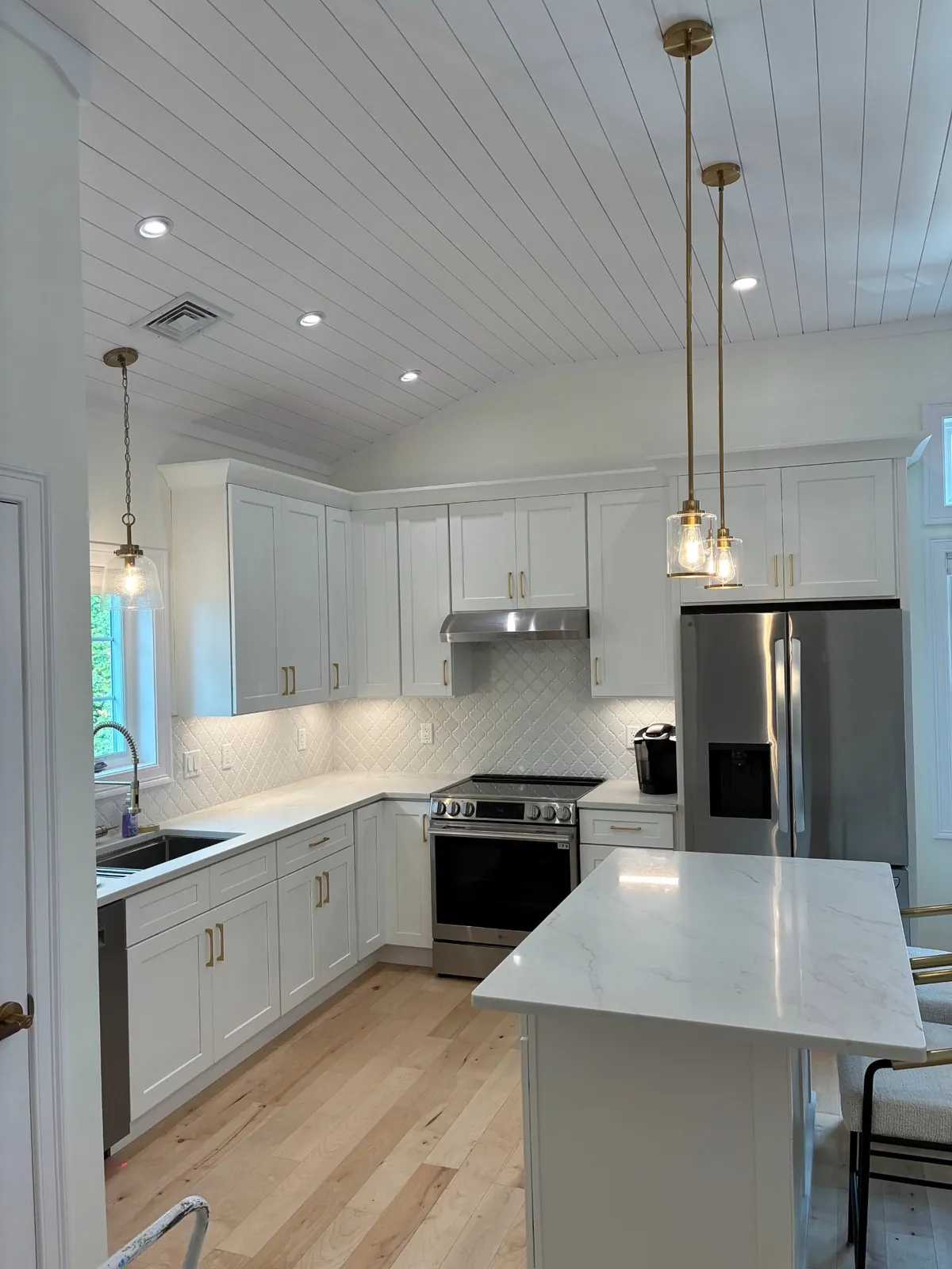 Pendant lights and recessed lighting in a renovated kitchen