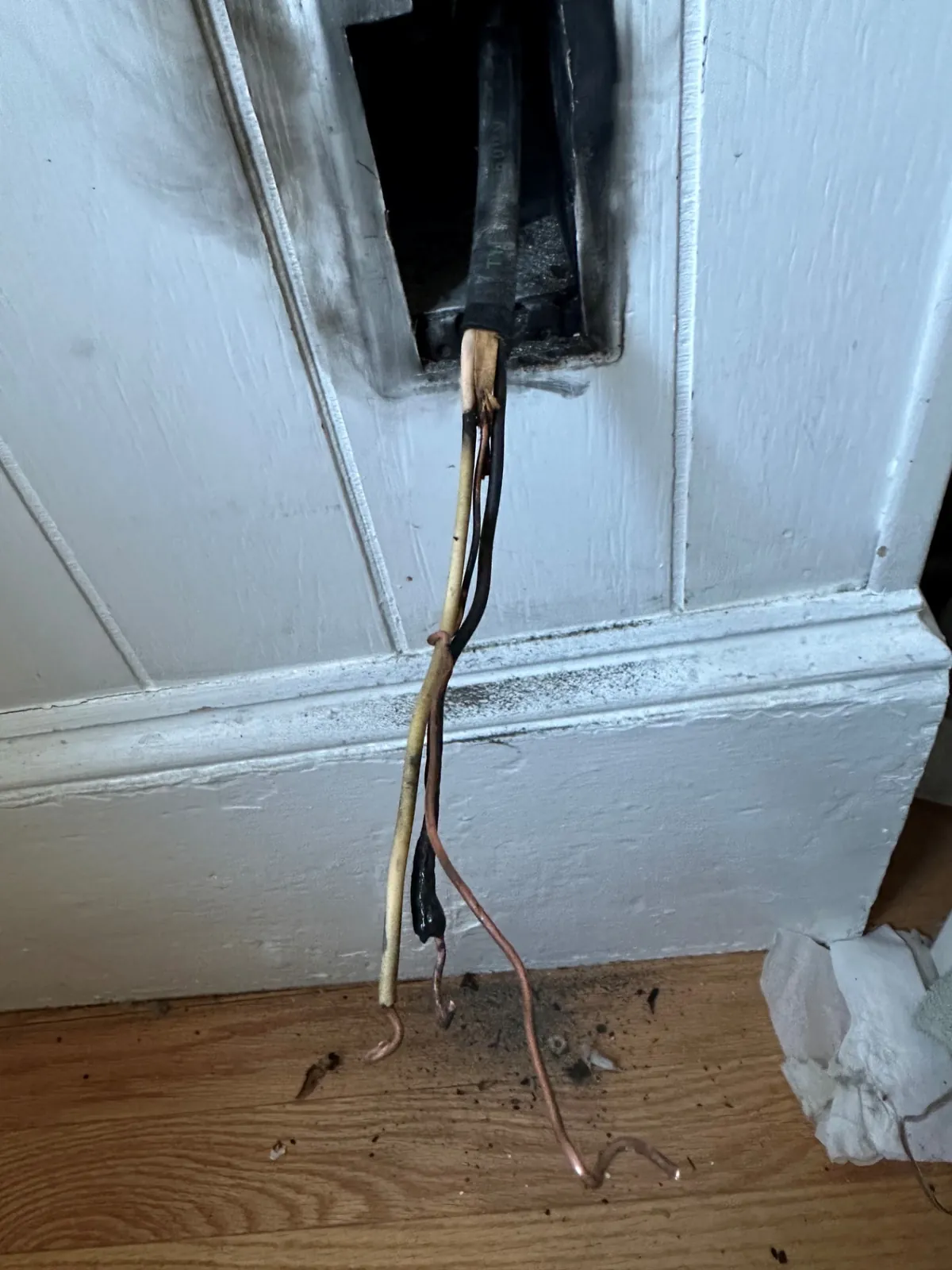 Removing heat-damaged wiring from a wall box in South Boston, MA