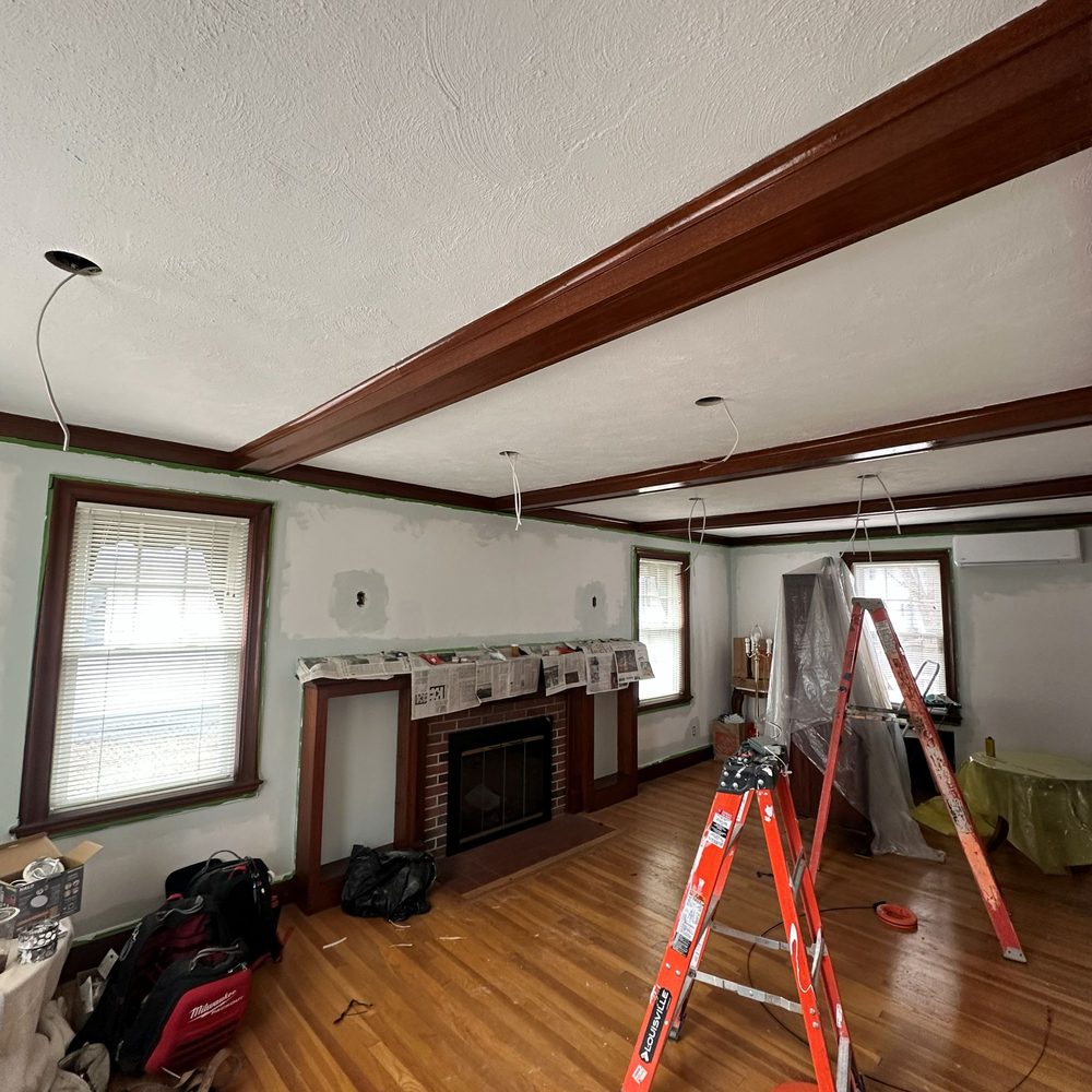 Boston Light & Power electrician installing recessed living room lighting in Milton, MA.