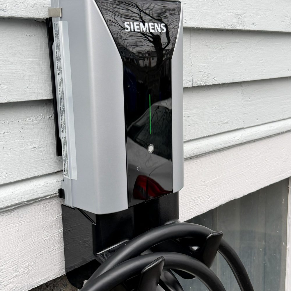 Boston Light & Power electrician installing a Siemens Level 2 EV charger in Milton, MA.